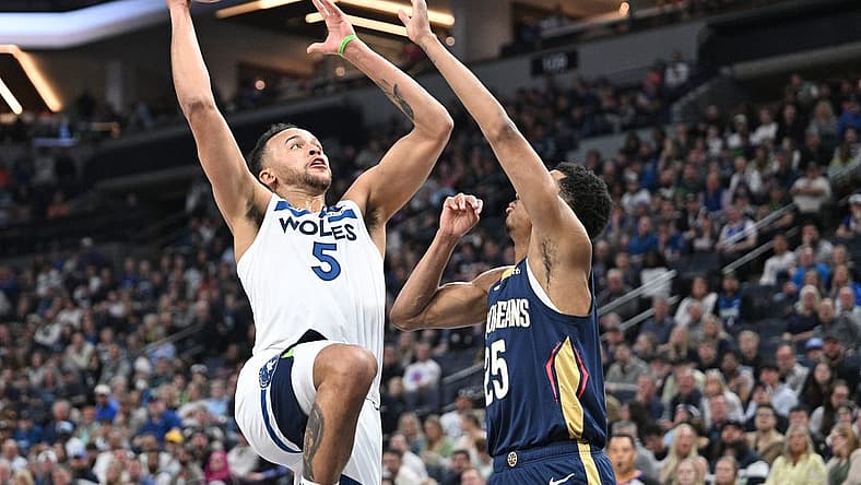 Apr 9, 2023; Minneapolis, Minnesota, USA; Minnesota Timberwolves forward Kyle Anderson (5) goes to the basket as New Orleans Pelicans guard Trey Murphy III (25) defends during the second quarter at Target Center. Mandatory Credit: Jeffrey Becker-USA TODAY Sports