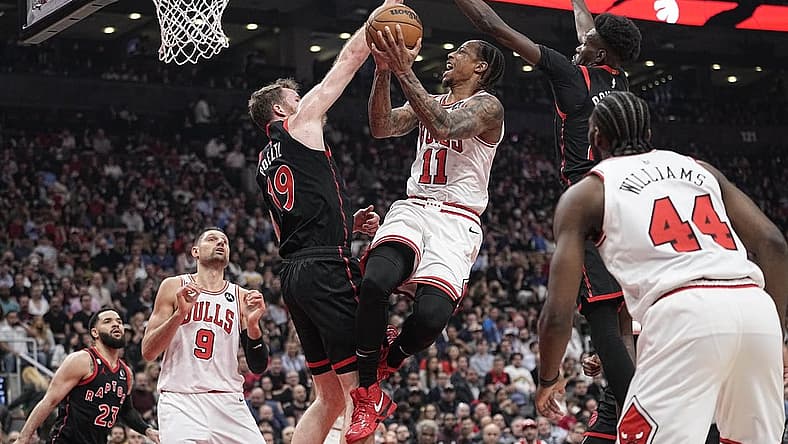 Apr 12, 2023; Toronto, Ontario, CAN; Toronto Raptors center Jakob Poeltl (19) and forward Chris Boucher (25) block a shot attempt by Chicago Bulls forward DeMar DeRozan (11) during the NBA Play-In game at Scotiabank Arena. Mandatory Credit: John E. Sokolowski-USA TODAY Sports