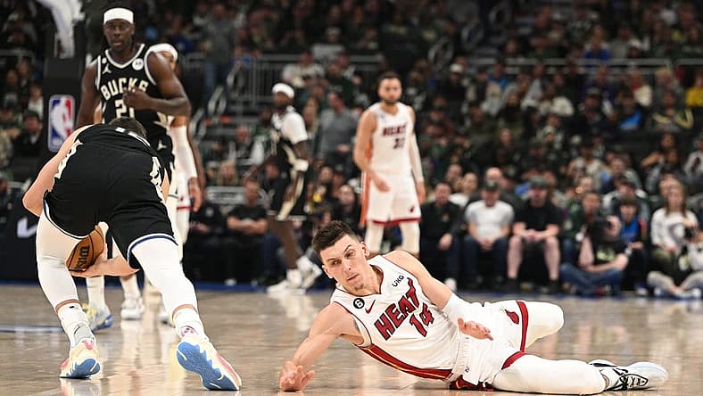 Apr 16, 2023; Milwaukee, Wisconsin, USA; Miami Heat guard Tyler Herro (14) injures his hand while diving for a loose ball against the Milwaukee Bucks during game one of the 2023 NBA Playoffs at Fiserv Forum. Mandatory Credit: Michael McLoone-USA TODAY Sports