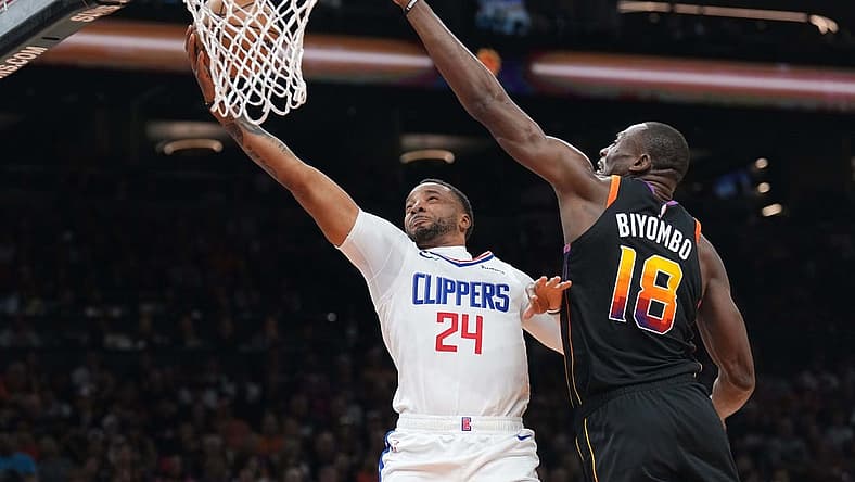 Apr 16, 2023; Phoenix, Arizona, USA; LA Clippers guard Norman Powell (24) puts up a layup against Phoenix Suns center Bismack Biyombo (18) during the first half of game one of the 2023 NBA playoffs at Footprint Center. Mandatory Credit: Joe Camporeale-USA TODAY Sports