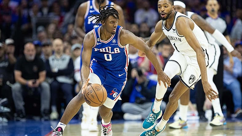 Apr 17, 2023; Philadelphia, Pennsylvania, USA; Philadelphia 76ers guard Tyrese Maxey (0) dribbles the ball  in front of Brooklyn Nets forward Mikal Bridges (1) during the second quarter in game two of the 2023 NBA playoffs at Wells Fargo Center. Mandatory Credit: Bill Streicher-USA TODAY Sports