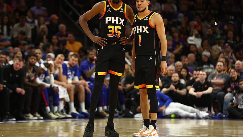 Apr 18, 2023; Phoenix, Arizona, USA; Phoenix Suns guard Devin Booker (1) with forward Kevin Durant (35) against the Los Angeles Clippers in the second half during game two of the 2023 NBA playoffs at Footprint Center. Mandatory Credit: Mark J. Rebilas-USA TODAY Sports