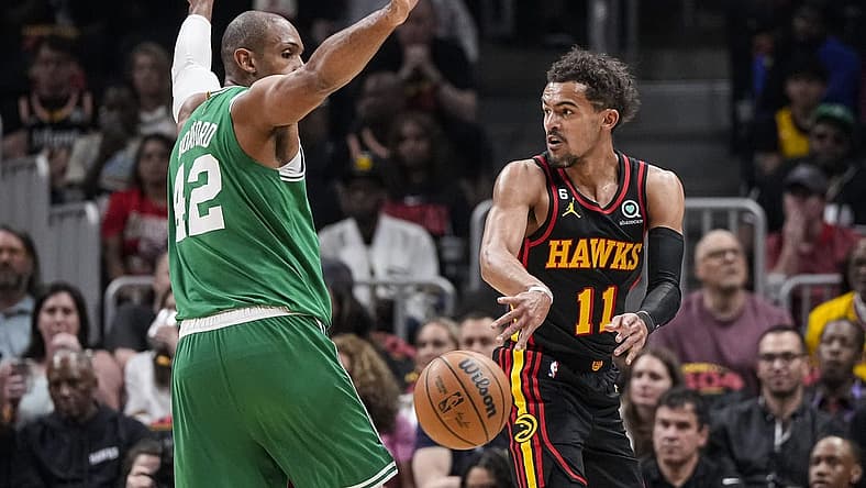 Apr 21, 2023; Atlanta, Georgia, USA; Atlanta Hawks guard Trae Young (11) passes behind Boston Celtics center Al Horford (42) during the first half during game three of the 2023 NBA playoffs at State Farm Arena. Mandatory Credit: Dale Zanine-USA TODAY Sports