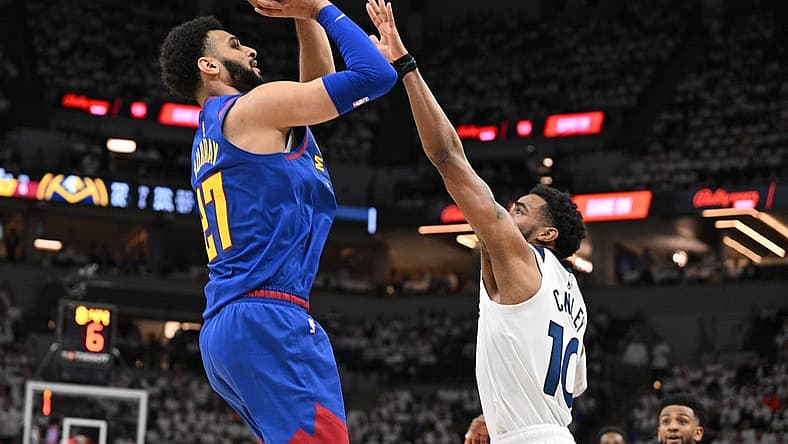 Apr 21, 2023; Minneapolis, Minnesota, USA; Denver Nuggets guard Jamal Murray (27) is defended by Minnesota Timberwolves guard Mike Conley (10) during the second quarter of game three of the 2023 NBA Playoffs at Target Center. Mandatory Credit: Jeffrey Becker-USA TODAY Sports