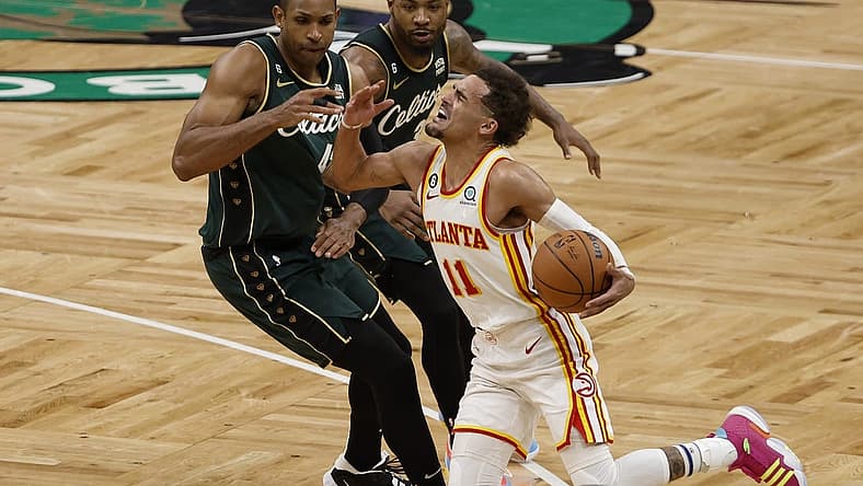 Apr 25, 2023; Boston, Massachusetts, USA; Atlanta Hawks guard Trae Young (11) gets fouled by Boston Celtics center Al Horford (42) during the fourth quarter of game five of the 2023 NBA playoffs at TD Garden. Mandatory Credit: Winslow Townson-USA TODAY Sports