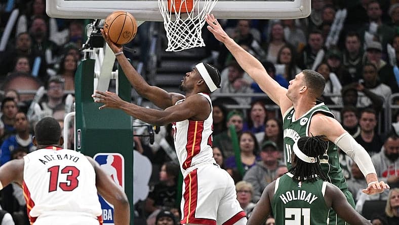 Apr 26, 2023; Milwaukee, Wisconsin, USA; Miami Heat forward Jimmy Butler (22) shoots the ball against Milwaukee Bucks center Brook Lopez (11)during game five of the 2023 NBA Playoffs at Fiserv Forum. Mandatory Credit: Michael McLoone-USA TODAY Sports