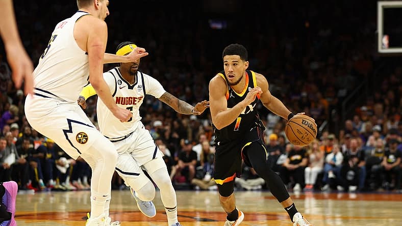 May 7, 2023; Phoenix, Arizona, USA; Phoenix Suns guard Devin Booker (1) against the Denver Nuggets in the first half during game four of the 2023 NBA playoffs at Footprint Center. Mandatory Credit: Mark J. Rebilas-USA TODAY Sports
