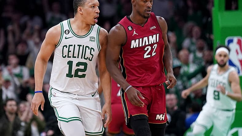 May 19, 2023; Boston, Massachusetts, USA; Boston Celtics forward Grant Williams (12) and Miami Heat forward Jimmy Butler (22) react after a play during the second half of game two of the Eastern Conference Finals for the 2023 NBA playoffs at TD Garden. Mandatory Credit: David Butler II-USA TODAY Sports
