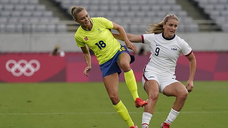 Sweden forward Fridolina Rolfo (18) collides with United States midfielder Lindsey Horan (9) during the first half in Group G play during the Tokyo 2020 Olympic Summer Games at Tokyo Stadium. Mandatory Credit: Jack Gruber-USA TODAY Network