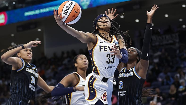 May 24, 2022; Chicago, Illinois, USA; Indiana Fever guard Destanni Henderson (33) goes to the basket against Chicago Sky guard Kahleah Copper (2) during the second half at Wintrust Arena. Mandatory Credit: Kamil Krzaczynski-USA TODAY Sports