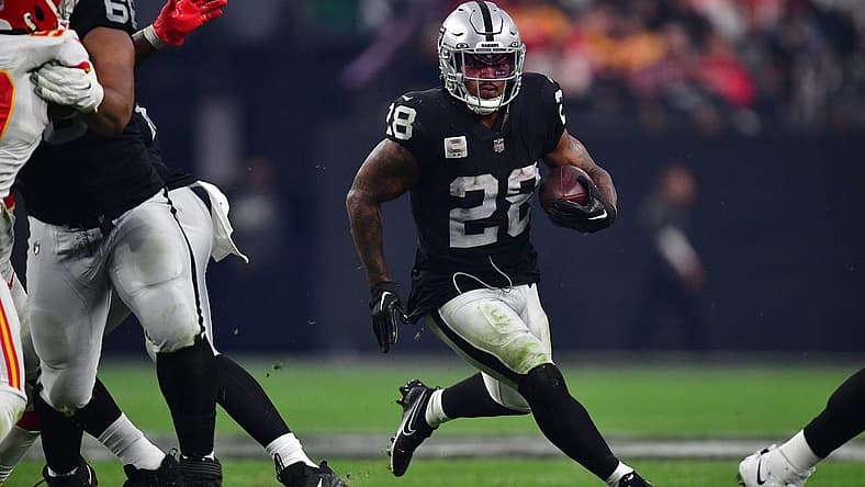 Jan 7, 2023; Paradise, Nevada, USA; Las Vegas Raiders running back Josh Jacobs (28) runs the ball against the Kansas City Chiefs during the second half at Allegiant Stadium. Mandatory Credit: Gary A. Vasquez-USA TODAY Sports