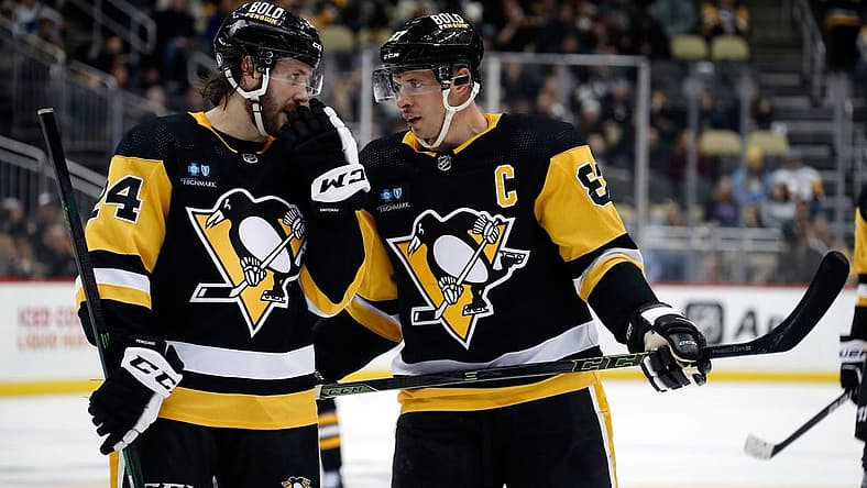 Jan 13, 2023; Pittsburgh, Pennsylvania, USA;  Pittsburgh Penguins defenseman Ty Smith (24) and center Sidney Crosby (87) talk on the ice against the Winnipeg Jets during the third period at PPG Paints Arena. Mandatory Credit: Charles LeClaire-USA TODAY Sports