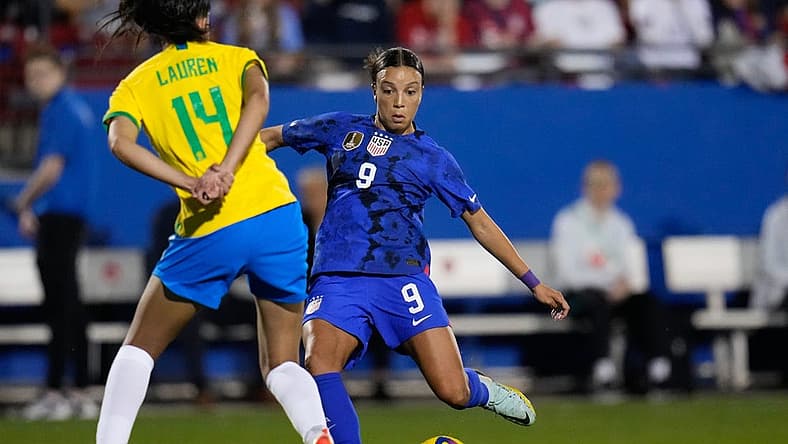 Feb 22, 2023; Frisco, Texas, USA; United States forward Mallory Swanson (9) passes the ball as Brazil defender Lauren (14) defends during the first half at Toyota Stadium. Mandatory Credit: Chris Jones-USA TODAY Sports