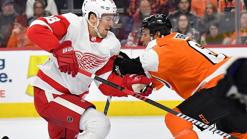 Mar 5, 2023; Philadelphia, Pennsylvania, USA; Detroit Red Wings defenseman Robert Hagg (38) is checked by Philadelphia Flyers defenseman Justin Braun (61) during the first period at Wells Fargo Center. Mandatory Credit: Eric Hartline-USA TODAY Sports