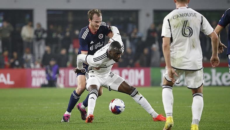 Mar 25, 2023; Washington, District of Columbia, USA; D.C. United forward Christian Benteke (20) controls the ball as New England Revolution defender Henry Kessler (4) defends in the first half at Audi Field. Mandatory Credit: Amber Searls-USA TODAY Sports