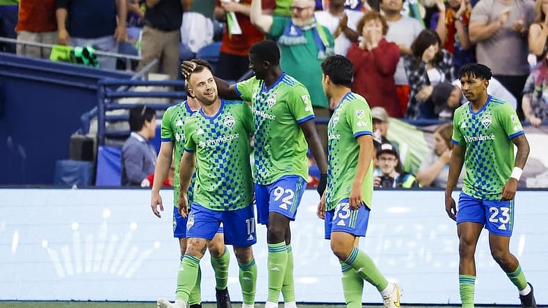 Jul 1, 2023; Seattle, Washington, USA; Seattle Sounders FC midfielder Albert Rusnak (11) celebrates with midfielder defender Abdoulaye Cissoko (92) after scoring a goal against the Houston Dynamo during the second half at Lumen Field. Seattle Sounders FC midfielder Leo Chu (23), right, walking back to midfield, assisted on the goal. Mandatory Credit: Joe Nicholson-USA TODAY Sports