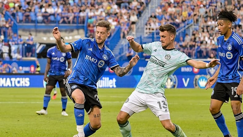 Jul 8, 2023; Montreal, Quebec, CAN; Atlanta United midfielder Amar Sejdic (13) and CF Montreal defender Gabriele Corbo (25) battle for possession during the first half at Stade Saputo. Mandatory Credit: Eric Bolte-USA TODAY Sports