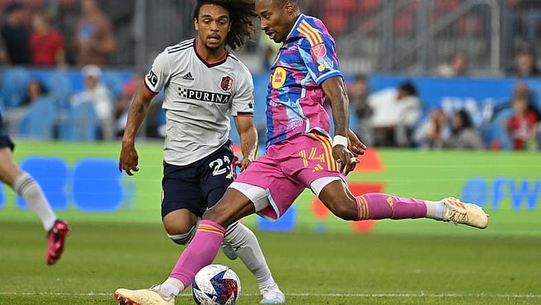 Jul 8, 2023; Toronto, Ontario, CAN; Toronto FC midfielder Mark-Anthony Kaye (14) shoots the ball past St. Louis City midfielder Aziel Jackson (25) in the first half at BMO Field. Mandatory Credit: Dan Hamilton-USA TODAY Sports