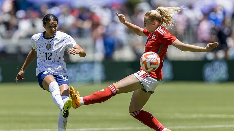 Jul 9, 2023; San Jose, California, USA; United States of America defender Alana Cook (12) passes past Wales midfielder Ceri Holland (7) during the first half at PayPal Park. Mandatory Credit: John Hefti-USA TODAY Sports