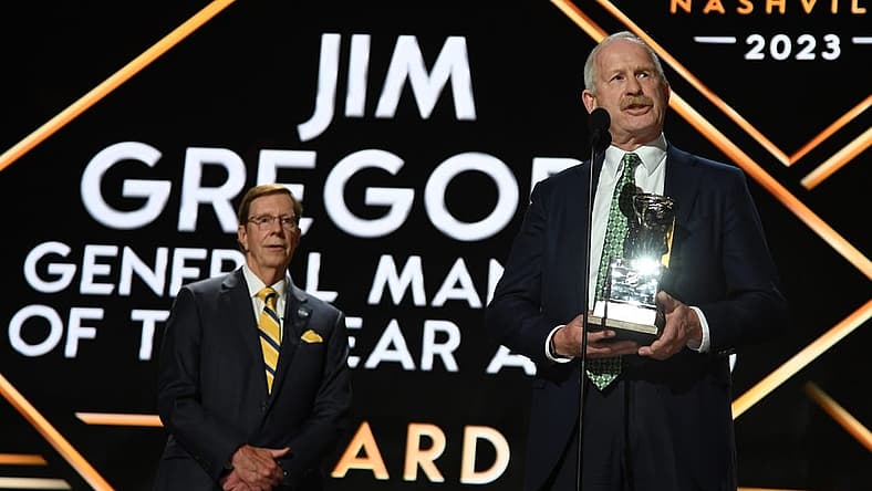 Jun 28, 2023; Nashville, Tennessee, USA; Dallas Stars general manager Jim Nill is awarded the Jim Gregory General Manager of the Year award by Nashville Predators general manager David Poile during the first round of the 2023 NHL Draft at Bridgestone Arena. Mandatory Credit: Christopher Hanewinckel-USA TODAY Sports