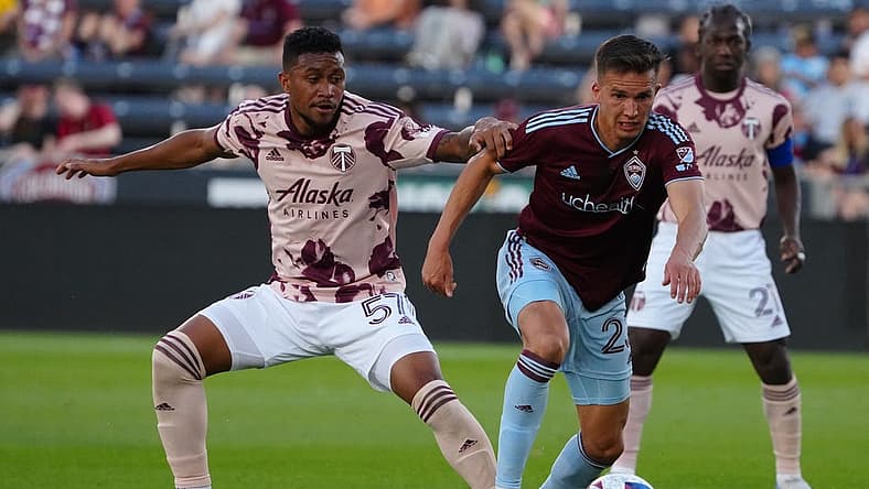 Jul 12, 2023; Commerce City, Colorado, USA; Colorado Rapids midfielder Cole Bassett (23) and Portland Timbers midfielder Victor Griffith (57) battle for the ball during the second half at Dick's Sporting Goods Park. Mandatory Credit: Ron Chenoy-USA TODAY Sports