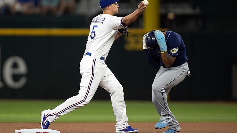 Jul 17, 2023; Arlington, Texas, USA; Texas Rangers shortstop Corey Seager (5) attempts to turn a double play as Tampa Bay Rays shortstop Wander Franco (5) runs to second base in the first inning at Globe Life Field. Mandatory Credit: Tim Heitman-USA TODAY Sports