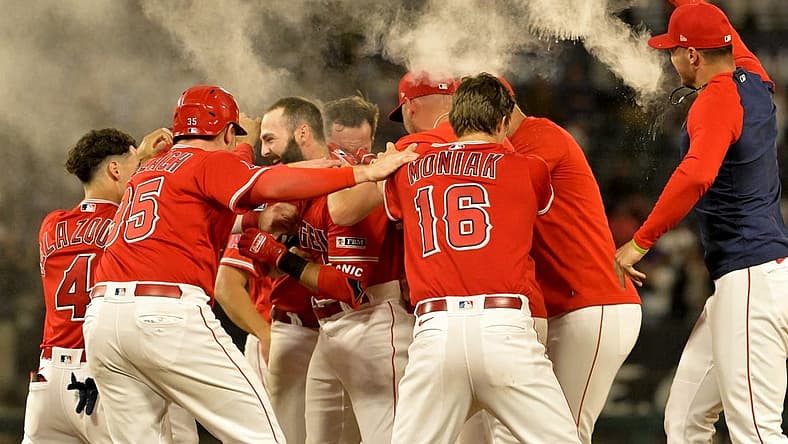 Jul 17, 2023; Anaheim, California, USA; Los Angeles Angels second baseman Michael Stefanic (38) is mobbed after a pinch hit RBI single in the 10th inning to defeat the New York Yankees at Angel Stadium. Mandatory Credit: Jayne Kamin-Oncea-USA TODAY Sports