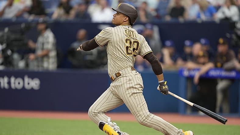 Jul 18, 2023; Toronto, Ontario, CAN; San Diego Padres left fielder Juan Soto (22) hits a two run home run against the Toronto Blue Jays during the first inning at Rogers Centre. Mandatory Credit: John E. Sokolowski-USA TODAY Sports