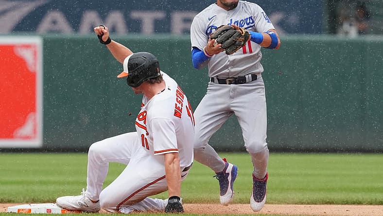 Jul 19, 2023; Baltimore, Maryland, USA; Los Angeles Dodgers shortstop Miguel Rojas (11) gets a force out on Baltimore Orioles second baseman Jordan Westburg (11) in the second inning at Oriole Park at Camden Yards. Mandatory Credit: Mitch Stringer-USA TODAY Sports