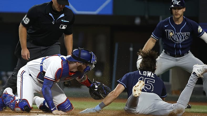 Jul 19, 2023; Arlington, Texas, USA; Texas Rangers catcher Jonah Heim (28) tags Tampa Bay Rays designated hitter Josh Lowe (15) out at home plate in the second inning at Globe Life Field. Mandatory Credit: Tim Heitman-USA TODAY Sports