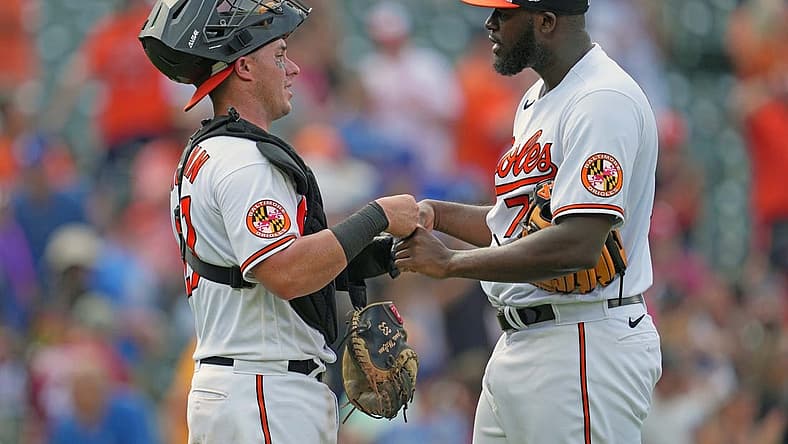 Jul 19, 2023; Baltimore, Maryland, USA; Baltimore Orioles pitcher Felix Bautista (right) greets catcher James McCann (left) after earning a save against the Los Angeles Dodgers at Oriole Park at Camden Yards. Mandatory Credit: Mitch Stringer-USA TODAY Sports