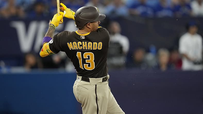 Jul 19, 2023; Toronto, Ontario, CAN; San Diego Padres third baseman Manny Machado (13) breaks his bat on a two run single against the Toronto Blue Jays during the fifth inning at Rogers Centre. Mandatory Credit: John E. Sokolowski-USA TODAY Sports