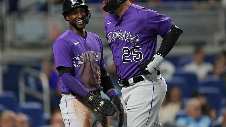 Jul 21, 2023; Miami, Florida, USA; Colorado Rockies first baseman C.J. Cron (25) is congratulated by left fielder Jurickson Profar (29) after hitting a two-run home run in the first inning against the Miami Marlins at loanDepot Park. Mandatory Credit: Jim Rassol-USA TODAY Sports
