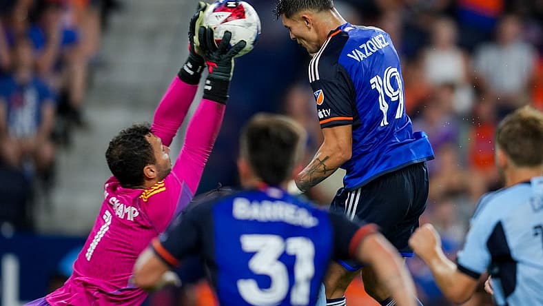 Jul 23, 2023; Cincinnati, OH, USA;  Sporting Kansas City goalkeeper John Pulskamp (1) attempts a save against FC Cincinnati forward Brandon Vazquez (19) in the second half at TQL Stadium. Mandatory Credit: Aaron Doster-USA TODAY Sports