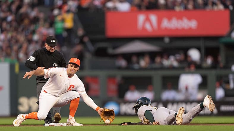 Jul 25, 2023; San Francisco, California, USA; Oakland Athletics second baseman Zack Gelof (20) slides during the sixth inning against San Francisco Giants shortstop Casey Schmitt (6) at Oracle Park. Mandatory Credit: Stan Szeto-USA TODAY Sports