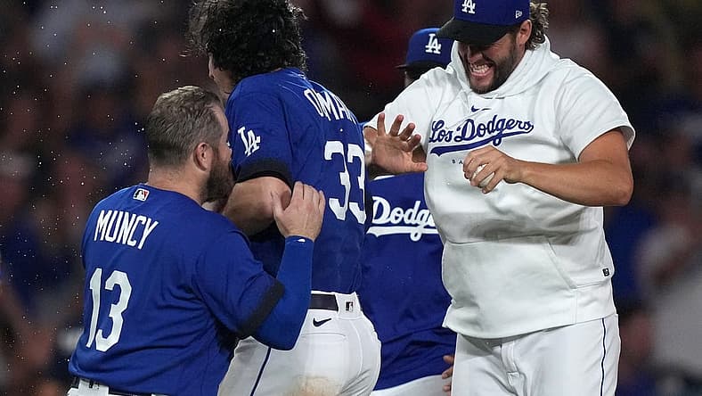Jul 25, 2023; Los Angeles, California, USA; Los Angeles Dodgers center fielder James Outman (33) celebrates with third baseman Max Muncy (13) and pitcher Clayton Kershaw after hitting a walk-off double in the 10th inning against the Toronto Blue Jays at Dodger Stadium. Mandatory Credit: Kirby Lee-USA TODAY Sports