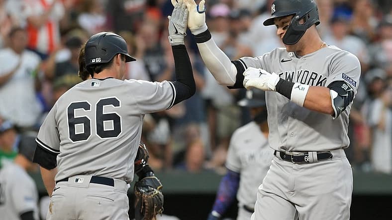 Jul 29, 2023; Baltimore, Maryland, USA; New York Yankees right fielder Aaron Judge (99) celebrates with catcher Kyle Higashioka (66) at home plate after hitting a two run home run in the third inning against the Baltimore Orioles at Oriole Park at Camden Yards. Mandatory Credit: Tommy Gilligan-USA TODAY Sports