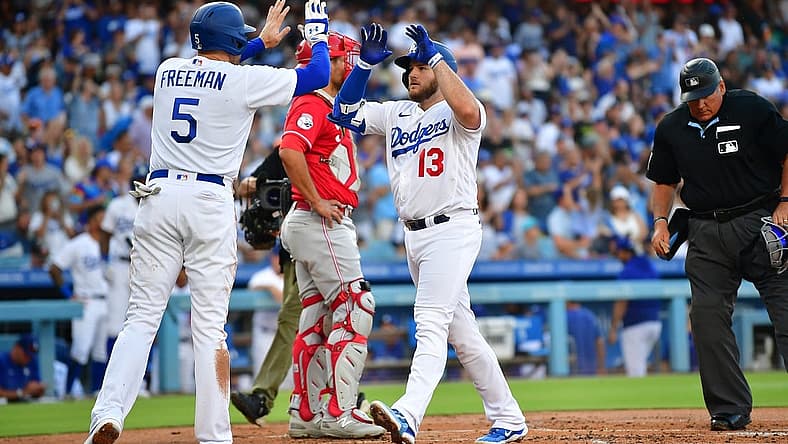 Jul 29, 2023; Los Angeles, California, USA; Los Angeles Dodgers third baseman Max Muncy (13) is greeted by first baseman Freddie Freeman (5) after hitting a two run home run against the Cincinnati Reds during the first inning at Dodger Stadium. Mandatory Credit: Gary A. Vasquez-USA TODAY Sports