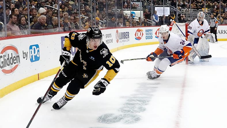 Mar 9, 2023; Pittsburgh, Pennsylvania, USA;  Pittsburgh Penguins left wing Drew O'Connor (10) moves the puck against the New York Islanders during the first period at PPG Paints Arena. Mandatory Credit: Charles LeClaire-USA TODAY Sports