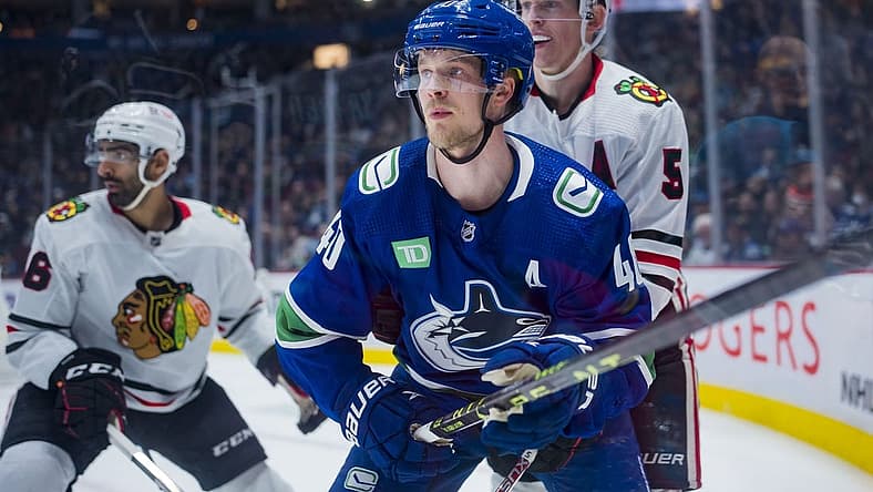 Apr 6, 2023; Vancouver, British Columbia, CAN; Chicago Blackhawks defenseman Connor Murphy (5) battles with Vancouver Canucks forward Elias Pettersson (40) in the first period at Rogers Arena. Mandatory Credit: Bob Frid-USA TODAY Sports