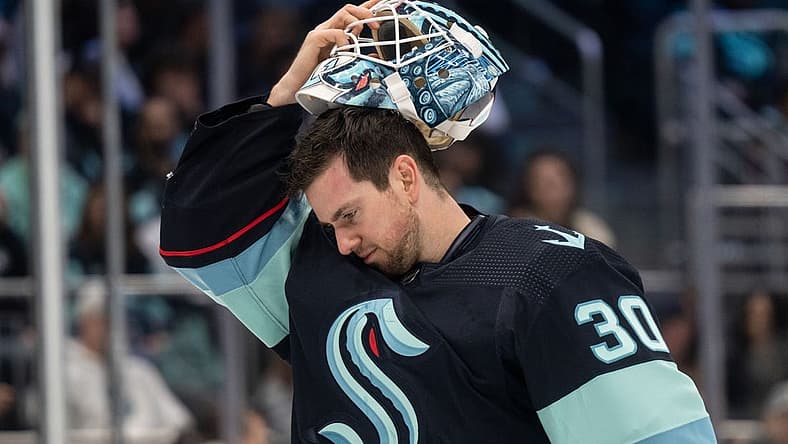 Apr 1, 2023; Seattle, Washington, USA; Seattle Kraken goalie Martin Jones (30) puts on his helmet during a game against the Los Angeles Kings at Climate Pledge Arena. Mandatory Credit: Stephen Brashear-USA TODAY Sports
