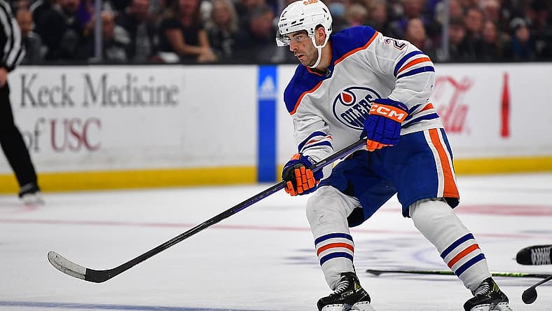 Apr 23, 2023; Los Angeles, California, USA; Edmonton Oilers defenseman Evan Bouchard (2) moves the puck against the Los Angeles Kings during the third period in game four of the first round of the 2023 Stanley Cup Playoffs at Crypto.com Arena. Mandatory Credit: Gary A. Vasquez-USA TODAY Sports