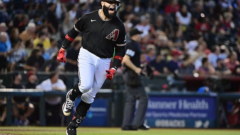 Jul 26, 2023; Phoenix, Arizona, USA; Arizona Diamondbacks third baseman Emmanuel Rivera (15) hits a solo home run in the sixth inning against the St. Louis Cardinals at Chase Field. Mandatory Credit: Matt Kartozian-USA TODAY Sports