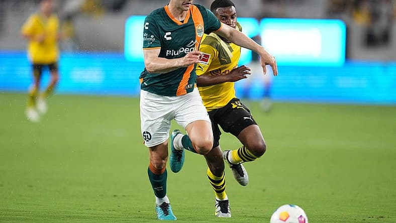 Jul 27, 2023; San Diego, California, USA; San Diego Loyal defender Grant Stoneman (5) battles for the ball against Borussia Dortmund forward Youssoufa Moukoko (18) during the first half at Snapdragon Stadium. Mandatory Credit: Ray Acevedo-USA TODAY Sports