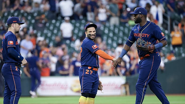 Jul 31, 2023; Houston, Texas, USA; Houston Astros third baseman Alex Bregman (2) and second baseman Jose Altuve (27) and  left fielder Yordan Alvarez (44) celebrate the win against the Cleveland Guardians  after defeating the Cleveland Guardians at Minute Maid Park. Mandatory Credit: Thomas Shea-USA TODAY Sports