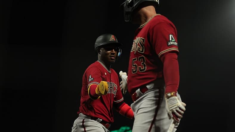 Jul 31, 2023; San Francisco, California, USA; Arizona Diamondbacks shortstop Geraldo Perdomo (2) is congratulated by first baseman Christian Walker (53) after scoring a run during the eleventh inning against the San Francisco Giants at Oracle Park. Mandatory Credit: Sergio Estrada-USA TODAY Sports