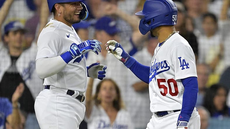 Aug 2, 2023; Los Angeles, California, USA; Los Angeles Dodgers shortstop Miguel Rojas (11) is greeted by right fielder Mookie Betts (50) after hitting a solo home run in the third inning against the Oakland Athletics at Dodger Stadium. Mandatory Credit: Jayne Kamin-Oncea-USA TODAY Sports