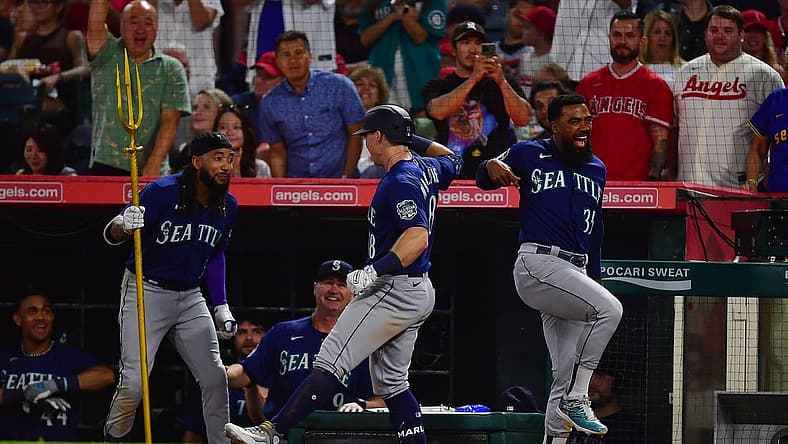 August 3, 2023; Anaheim, California, USA; Seattle Mariners left fielder Cade Marlowe (18) is greeted by shortstop J.P. Crawford (3) and designated hitter Teoscar Hernandez (35) after hitting a grand slam home run against the Los Angeles Angels during the ninth inning at Angel Stadium. Mandatory Credit: Gary A. Vasquez-USA TODAY Sports