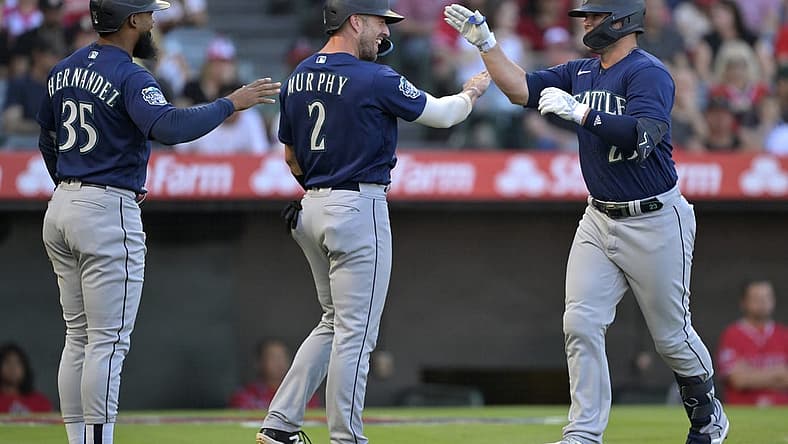 Aug 4, 2023; Anaheim, California, USA;  Seattle Mariners first baseman Ty France (23) is greeted by right fielder Teoscar Hernandez (35) and catcher Tom Murphy (2) after hitting a three run home run in the first inning against the Los Angeles Angels at Angel Stadium. Mandatory Credit: Jayne Kamin-Oncea-USA TODAY Sports