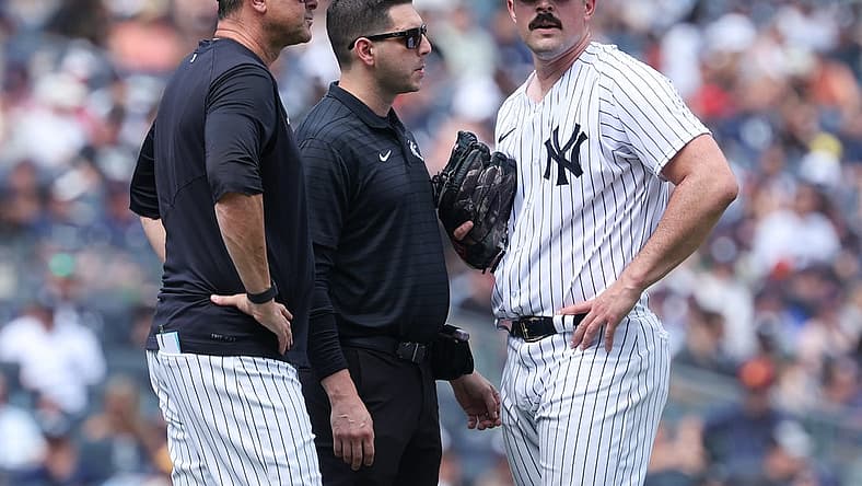 Aug 6, 2023; Bronx, New York, USA; New York Yankees starting pitcher Carlos Rodon (55) talks with medical staff and manager Aaron Boone (17) after an injury during the third inning against the Houston Astros at Yankee Stadium. Mandatory Credit: Vincent Carchietta-USA TODAY Sports